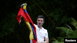 Venezuela's opposition leader Leopoldo Lopez, granted house arrest after more than three years in jail, salutes supporters in Caracas, Venezuela, July 8, 2017.