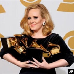 Adele holds her Grammy Awards