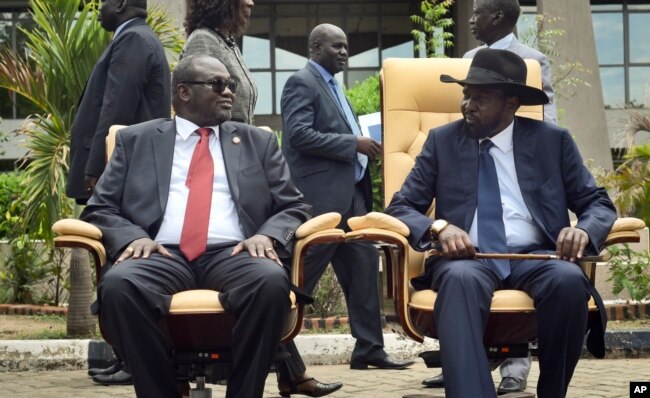 FILE - South Sudan's then-First Vice President Riek Machar, left, looks across at President Salva Kiir, right, as the two sit to be photographed, April 29, 2016.