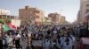 FILE- Tens of thousands of Sudanese calling for a civilian government march near the presidential palace in Khartoum, Sudan, Tuesday, Nov. 30, 2021