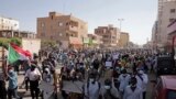 FILE- Tens of thousands of Sudanese calling for a civilian government march near the presidential palace in Khartoum, Sudan, Tuesday, Nov. 30, 2021