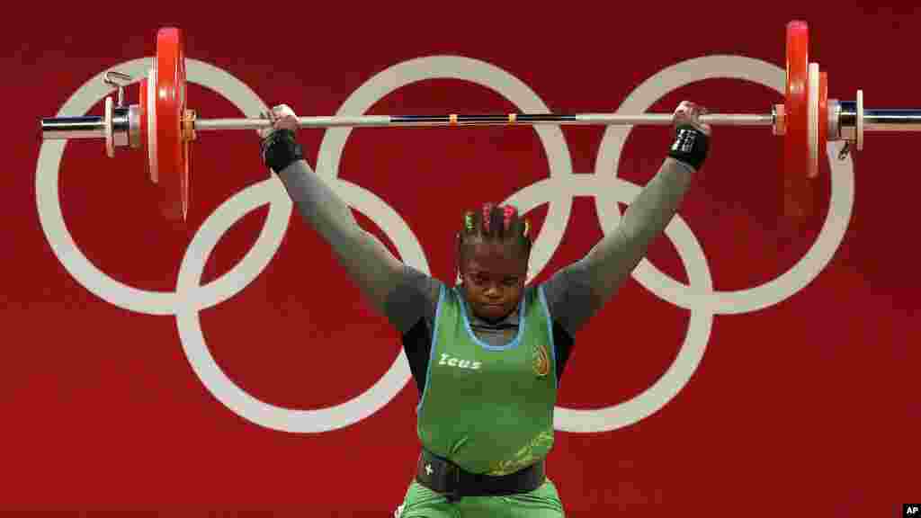 Jeanne Gaelle Eyenga Mboosi of Cameroon competes in the women&#39;s 76kg weightlifting event, at the 2020 Summer Olympics, Sunday, Aug. 1, 2021, in Tokyo, Japan. (AP Photo/Luca Bruno)