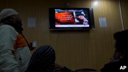 FILE - People watch a TV news report about the leader of the Pakistani Taliban, Mullah Fazlullah, at a coffee shop in Islamabad, Pakistan, Nov. 7, 2013.