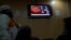 FILE - People watch a TV news report about the leader of the Pakistani Taliban, Mullah Fazlullah, at a coffee shop in Islamabad, Pakistan, Nov. 7, 2013.