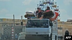 TOPSHOT - Syrian civilians flee on August 22, 2019 a conflict zone in Syria's rebel-held northwestern region of Idlib, where government bombardment has killed hundreds since late April, near Maar Shurin on the outskirts of Maaret al-Numan. Damascus…
