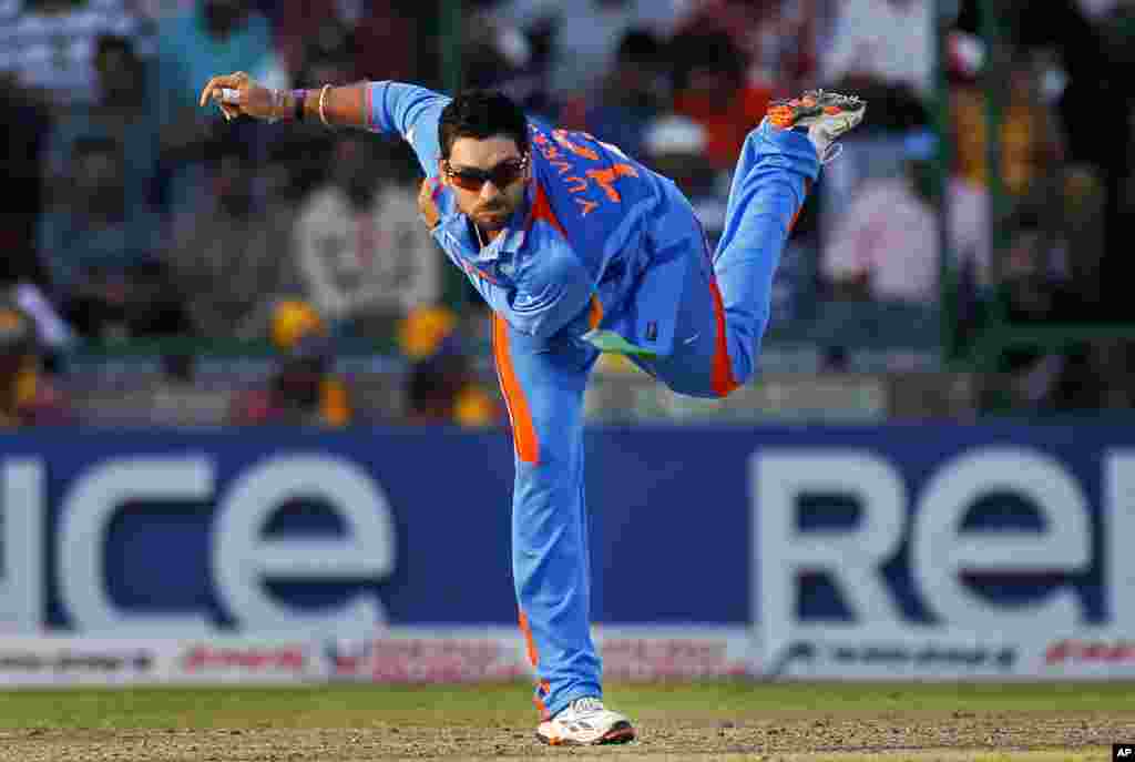 India's Yuvraj Singh dives bowls during their ICC Cricket World Cup group B match against The Netherlands in New Delhi March 9, 2011. REUTERS/Adnan Abidi (INDIA - Tags: SPORT CRICKET)