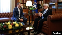 Greek Prime Minister Alexis Tsipras, left, briefs Greek President Prokopis Pavlopoulos on developments on the name dispute with Macedonia, in Athens, Greece May 19, 2018. 