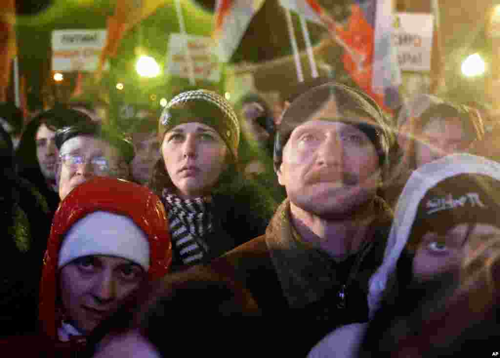 Russian opposition members listen during a rally in Moscow, Russia. Several thousand people have protested against Prime Minister Vladimir Putin and his party, which won the largest share of a parliamentary election that observers said was rigged. (AP/Iva