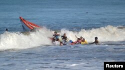 Ombak besar menghantam sebuah perahu nelayan di lepas pantai Pasie Nan Tigo, Padang, Sumatra Barat (foto ilustrasi - Antara/Reuters).