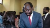 Prominent South Sudanese activist and economist Peter Biar Ajak talks to his wife Nyathon Hoth Mai, left, after he was sentenced to two years in prison, in a courtroom in the capital Juba, South Sudan, June 11, 2019.