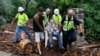 Will Pitner is rescued by emergency workers and neighbor Jeff Writer after a night trapped outside on high ground above his home as it filled with water after days of record rain and flooding at the base of Boulder Canyon, Colorado, Sept. 13, 2013.