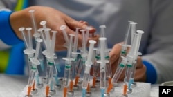 A nurse prepares vaccines in the Wizink Center, currently used for COVID-19 vaccinations in Madrid, Spain, Dec. 1, 2021.