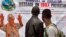 The image of Liberia President Ellen Johnson Sirleaf, left, appears on a public information banner warning people about the Ebola virus in the city of Monrovia, Aug. 8, 2014.