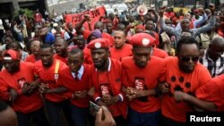 Ugandan musician turned politician, Robert Kyagulanyi (C) leads activists during a demonstration against new taxes including a levy on access to social media platforms in Kampala, July 11, 2018.