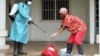 A Liberian Red Cross employee disinfects after removing a body suspected of having Ebola, Monrovia, September 2014. (Credit: International Alert)