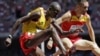 FILE - Uganda's Benjamin Kiplagat, front, competes in round one of the men's 3000m steeplechase during the World Athletic Championships at the Bird's Nest stadium in Beijing, Saturday, Aug. 22, 2015.