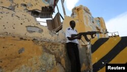 FILE - A Somali traffic policeman stands guard near the scene of a suicide car bomb explosion outside the traffic police headquarters in Somalia's capital Mogadishu. Abukar Arman, the former Special Representative of Somalia to Washington, said Wednesday the United States has been weak in using “soft power” in its effort to support the government attain security and political stability.