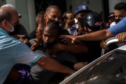 FILE - Police detain an anti-government demonstrator during a protest in Havana, Cuba, July 11, 2021.