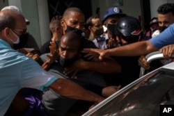 FILE - Police detain an anti-government demonstrator during a protest in Havana, Cuba, July 11, 2021.