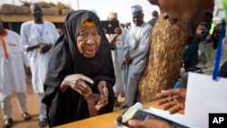 FILE - An elderly Nigerian woman is seen participating in elections in Daura, Nigeria, March 28, 2015.