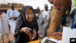 FILE - An elderly Nigerian woman is seen participating in elections in Daura, Nigeria, March 28, 2015. Life expectancy has risen by 9.4 years to 60 years in Africa, the World Health Organizations says.