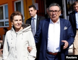 FILE - Aydin Dogan, founder and honorary president of Dogan Holding, and his wife, Sema Dogan, leave a polling station during a referendum in Istanbul, April 16, 2017.