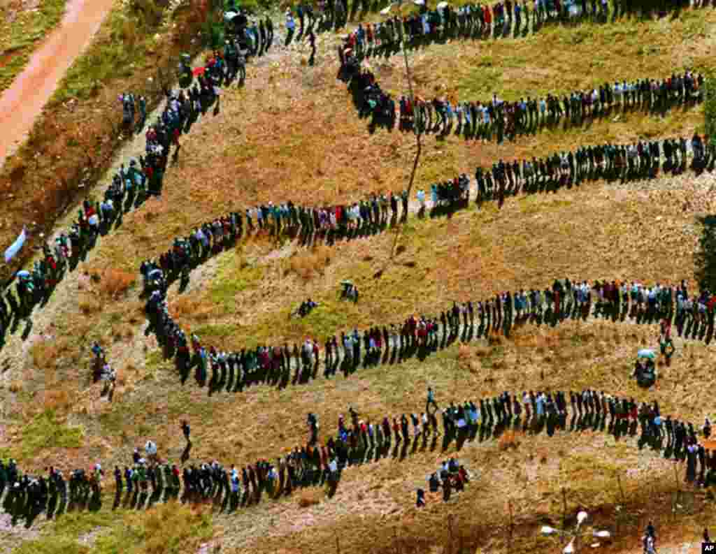 An April 27, 1994 aerial file photo shows long lines of people queuing outside the polling station in the black township of Soweto, in the southwest suburbs of Johannesburg, South Africa. (AP)