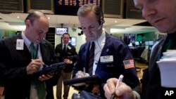 Traders work on the floor of the New York Stock Exchange, March 17, 2014.