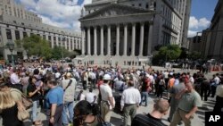 People stand in Foley Square in New York after being evacuated from the Federal and State buildings that surround it Tuesday, Aug. 23, 2011. The 5.8 magnitude earthquake centered northwest of Richmond, Va., shook much of Washington, D.C., and was felt as far north as Rhode Island and New York City. 