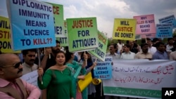 FILE - Pakistani protesters stage a rally demanding a trial for American diplomat involved in a vehicle crash that killed a person, in Islamabad, Pakistan, April 10, 2018.