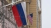 A Russian flag flies next to a U.S. flag at the U.S. Embassy in Moscow on March 13, 2025. U.S. special envoy Steve Witkoff arrived in Moscow Thursday to meet with Russian officials on a Ukraine-Russia ceasefire proposal.