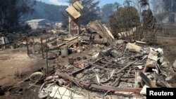 A house that has been destroyed by a bushfire can be seen near the town of Cobden, southwest of Melbourne in Australia, March 18, 2018.