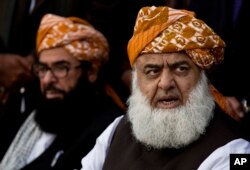 FILE - Maulana Fazal-ur-Rahman, right, pro-Taliban cleric and chief of religious party Jamiat Ulema-i-Islam addresses a news conference with Abdul Ghafoor Haidari in Islamabad, Pakistan, Feb. 3, 2014.