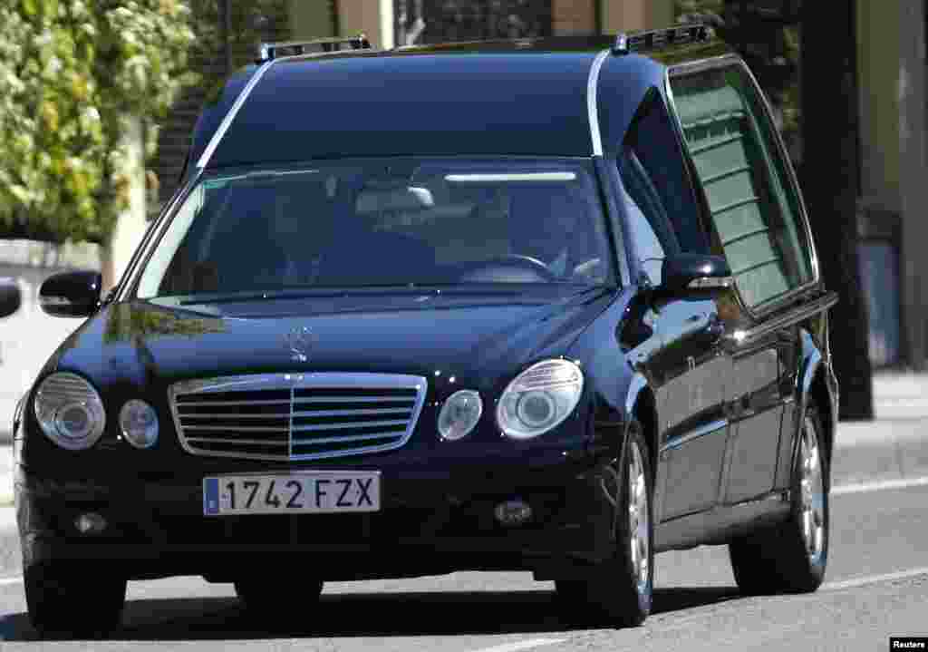A hearse carries the coffin of Spanish priest Miguel Pajares, 75, the first European infected by a strain of Ebola, Carlos III Hospital in Madrid, Spain, Aug. 12, 2014.