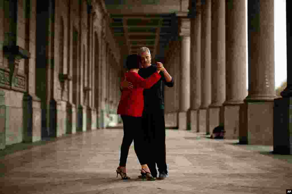 A couple dances underneath the arcade of the Royal Military Museum at Cinquantenaire Park in Brussels, Belgium.