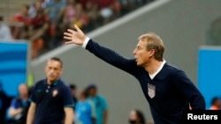 U.S. coach Juergen Klinsmann gives instructions to his players during their 2014 World Cup Group G soccer match against Portugal at the Amazonia arena in Manaus, Brazil, June 22, 2014.