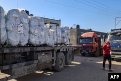 FILE —Humanitarian aid from the German Red Cross that entered Gaza by truck through the Kerem Shalom (Karm Abu Salem) border crossing in the southern part of the Palestinian territory on February 17, 2024, waits to be unloaded in Rafah on the southern Gaza Strip.