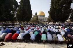 FILE - Palestinians pray inside the al-Aqsa Mosque compound in Jerusalem's Old City, July 27, 2017.