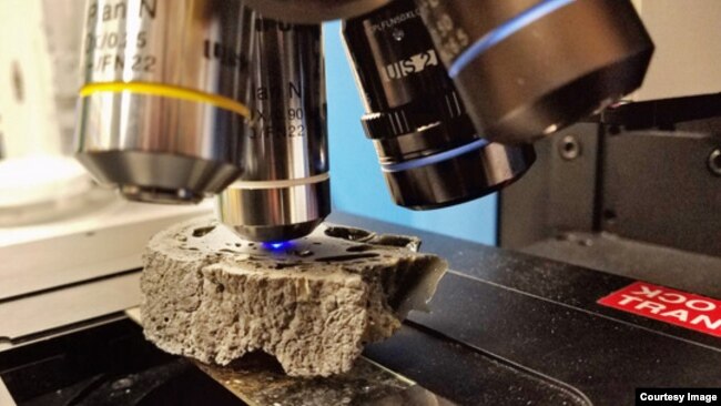 A cut sample of fulgurite being analyzed using Raman spectroscopy at the University of Chicago. (Yale University)