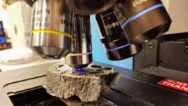 A cut sample of fulgurite being analyzed using Raman spectroscopy at the University of Chicago. (Yale University)