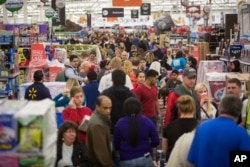 FILE - Customers save big at Wal-Mart's Black Friday shopping event in Rogers, Ark, Nov. 26, 2015.