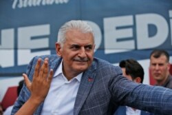 Binali Yildirim, mayoral candidate for Istanbul from Turkey's ruling Justice and Development Party, AKP, salutes supporters following a rally in Istanbul, June 21, 2019.