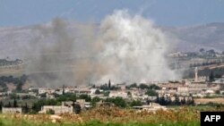 Smoke billows above buildings during reported shelling by government and allied forces, in the town of Hbeit in the southern countryside of rebel-held Idlib province, Syria, May 3, 2019.