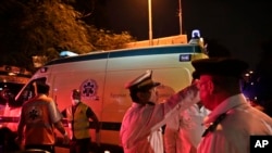 Police officers direct ambulances with bodies of Russian plane crash victims outside Zeinhom morgue in Cairo, Egypt, Oct. 31, 2015. 