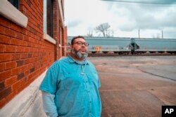 Thommy Hill stands outside the Cabell County/Huntington Health Department, where he works in the harm reduction program, in Huntington, W.Va., on Wednesday, Dec. 5, 2018. (AP Photo/Tyler Evert)