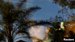 Oscar Pistorius is seen through a car window as he leaves court after being granted bail, in Pretoria, South Africa, Feb. 22, 2013.