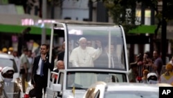 Pope Francis waves to the crowds after his arrival in Santiago, Chile, Jan. 15, 2018. 