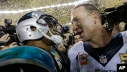 Carolina Panthers’ Cam Newton, left, talks to Denver Broncos’ Peyton Manning (18) after the NFL Super Bowl 50 football game, Feb. 7, 2016.