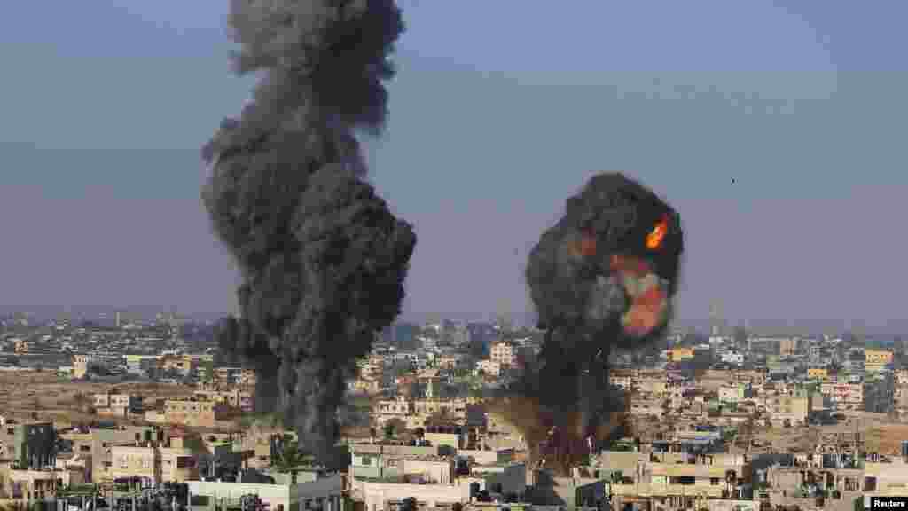 Smoke and flames are seen following what police said was an Israeli air strike in Rafah in the southern Gaza Strip July 9, 2014.
