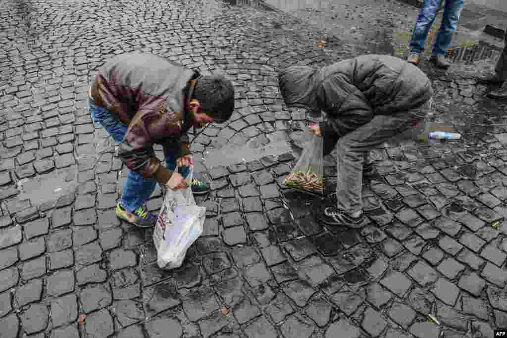 Children collect bullet shells off the streets of Sur district in the mainly Kurdish city of Diyarbakir, after a curfew was partially lifted. Tensions are running high throughout Turkey&#39;s restive southeast, as security forces have been imposing curfews in several towns in a bid to root out Kurdistan Workers&#39; Party (PKK) rebels from urban centers.